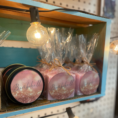 Three local candle wax blocks posed on a shelf.